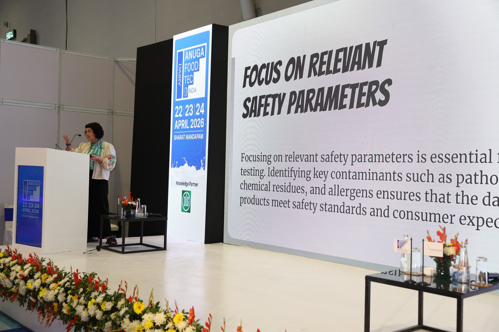 Keynote speaker presenting food safety parameters on the big screen