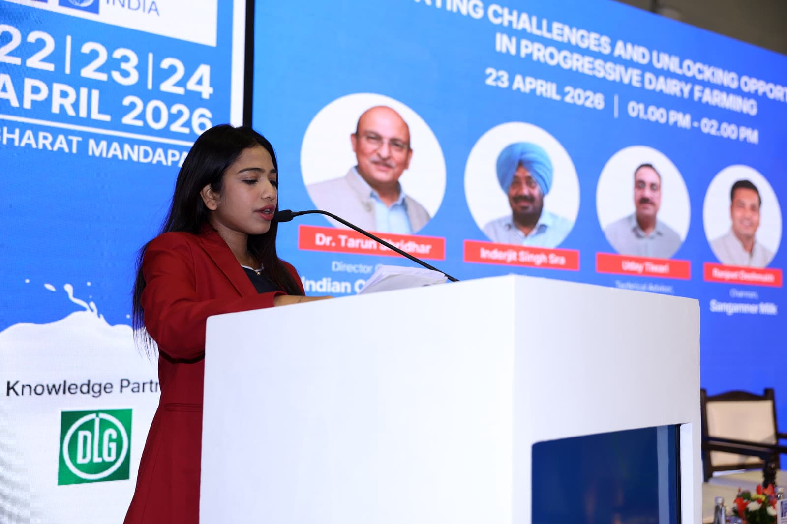 Young woman presenting at conference podium